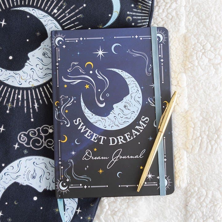 An A5 journal with a moon and stars cover and the words Sweet Dreams