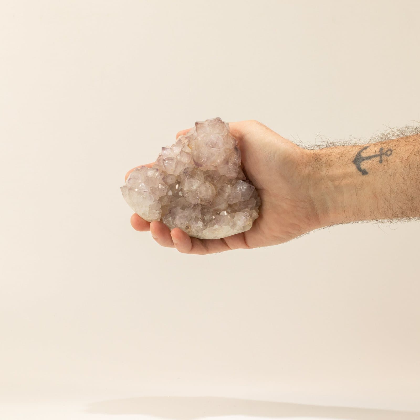 Opened amethyst geodes showing purple crystal interiors inside rough shells