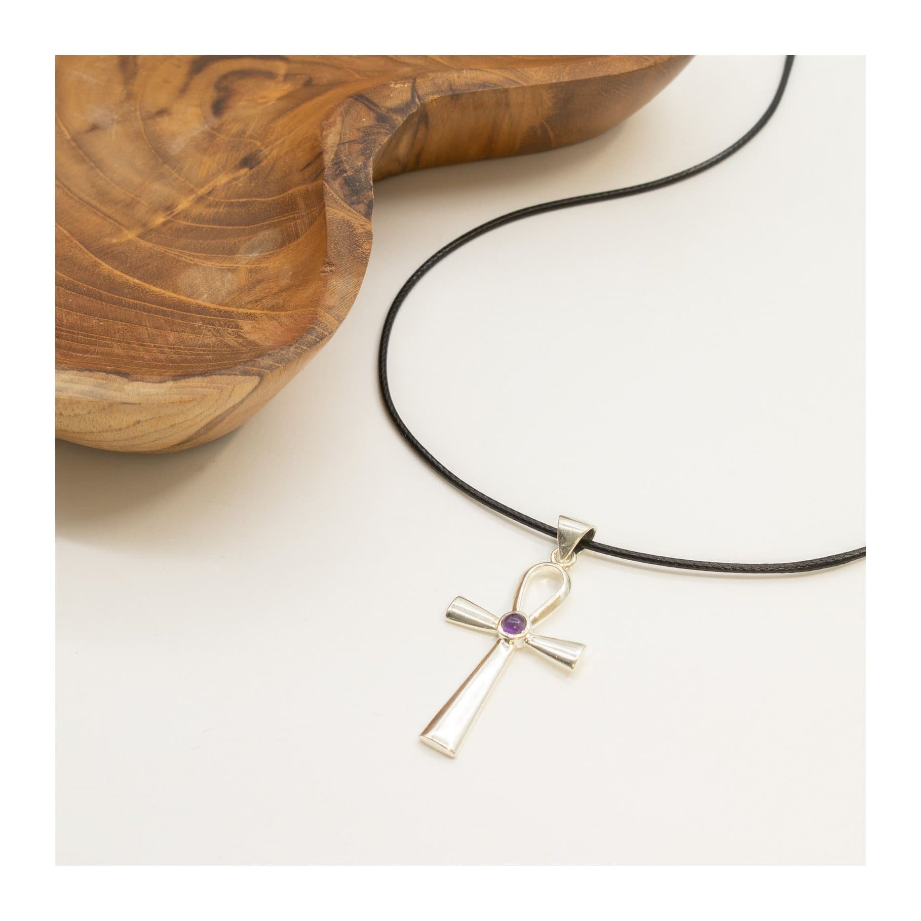Silver-plated ankh pendant with a small purple stone, on a black cord