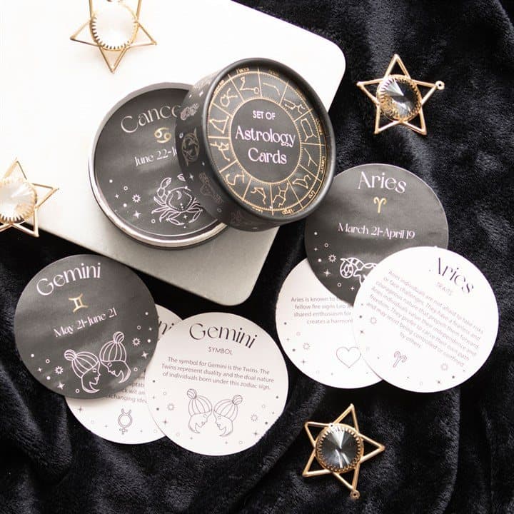 Set of circular astrology cards in a white cardboard box