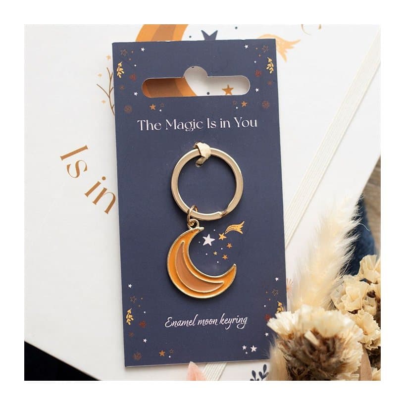 Moon-themed enamel and metal keyring on a header card