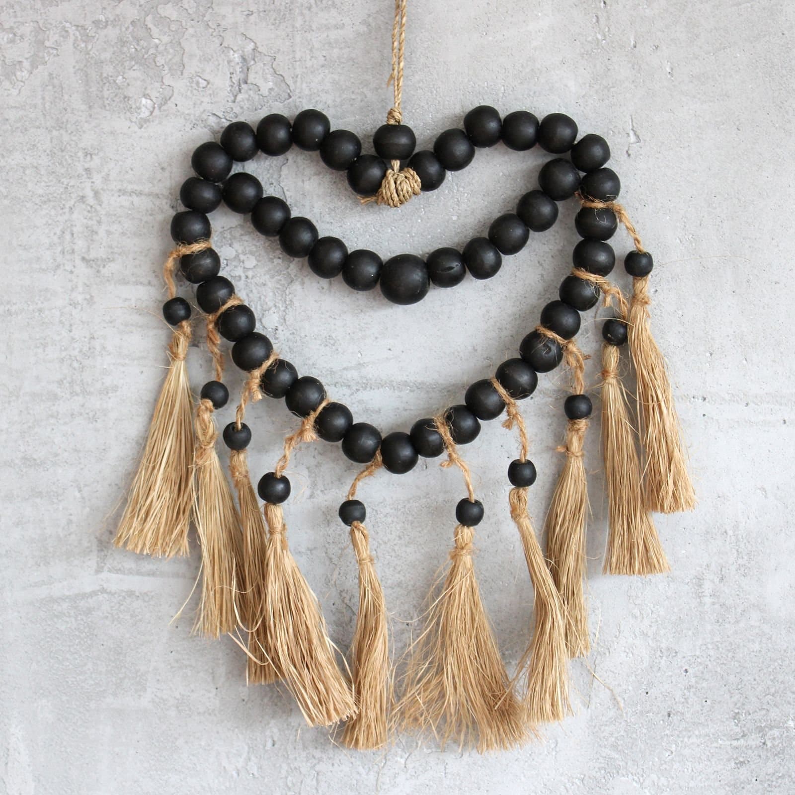 Heart-shaped mobile made with raffia and pinewood beads