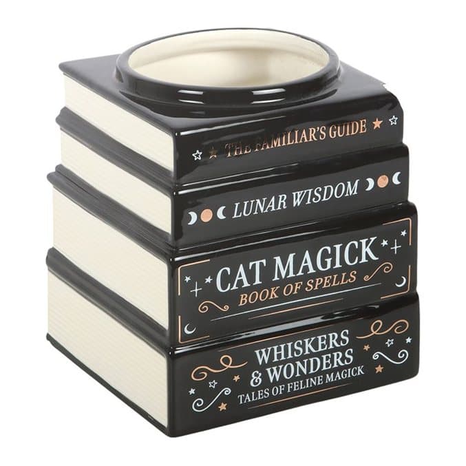 Black ceramic vase shaped like a stack of books with mystical titles