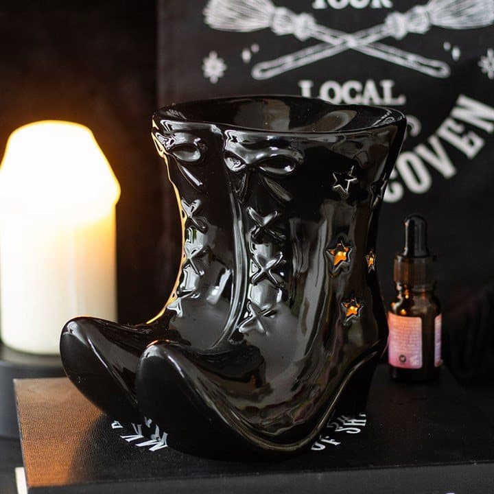 Black ceramic oil burner shaped like witch boots with star cut-outs