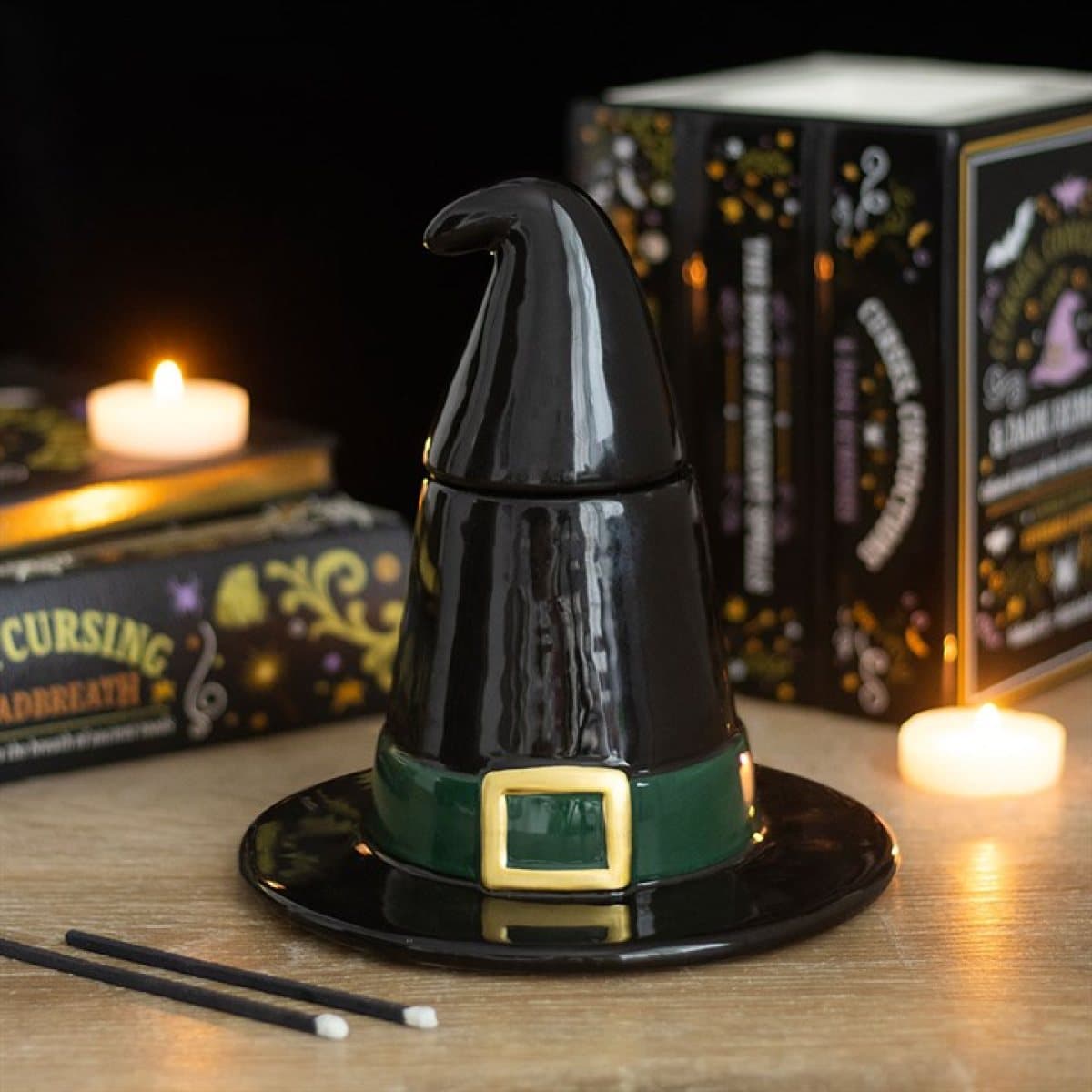 Black ceramic witch hat oil burner with a green buckle