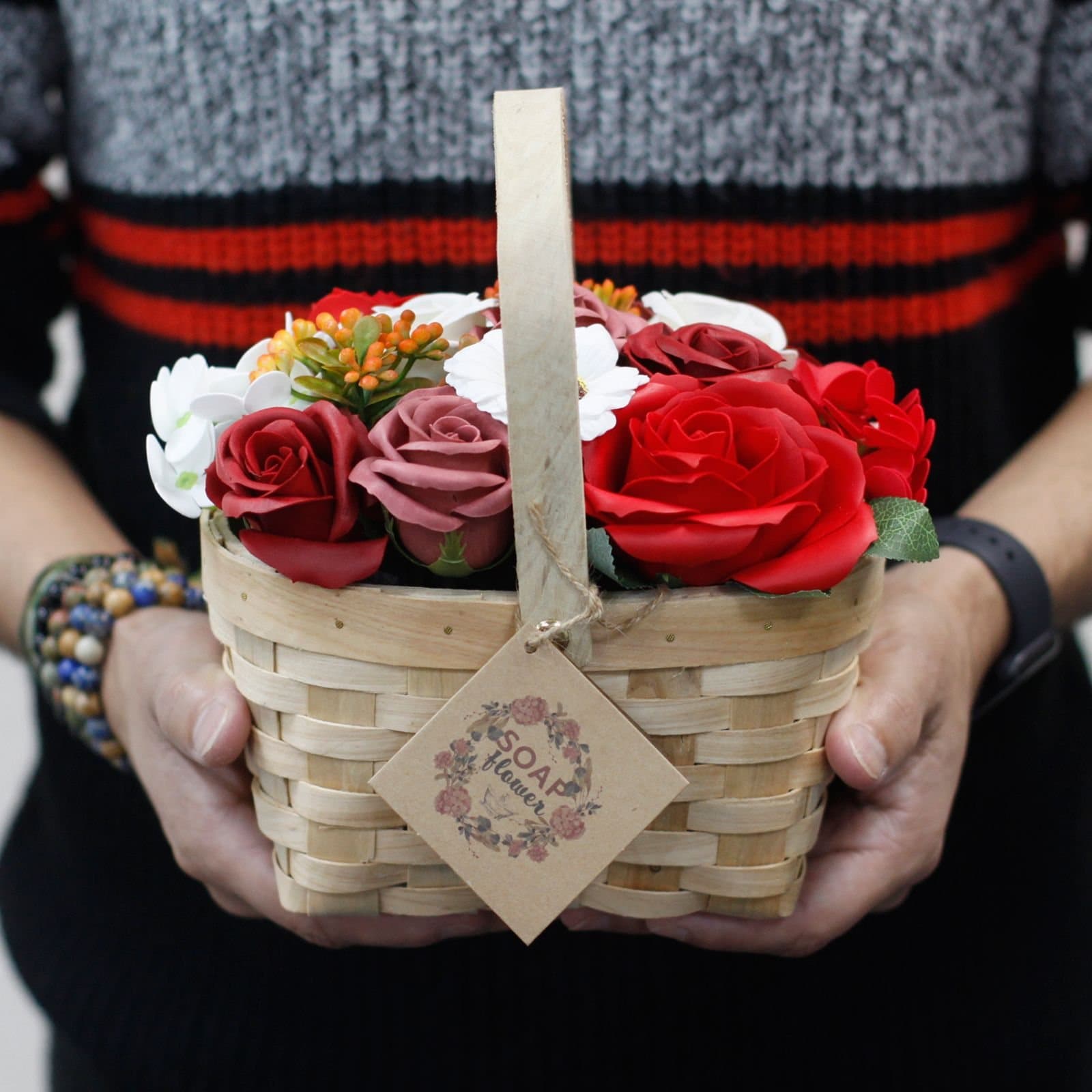 Soap flower bouquet in a wicker basket
