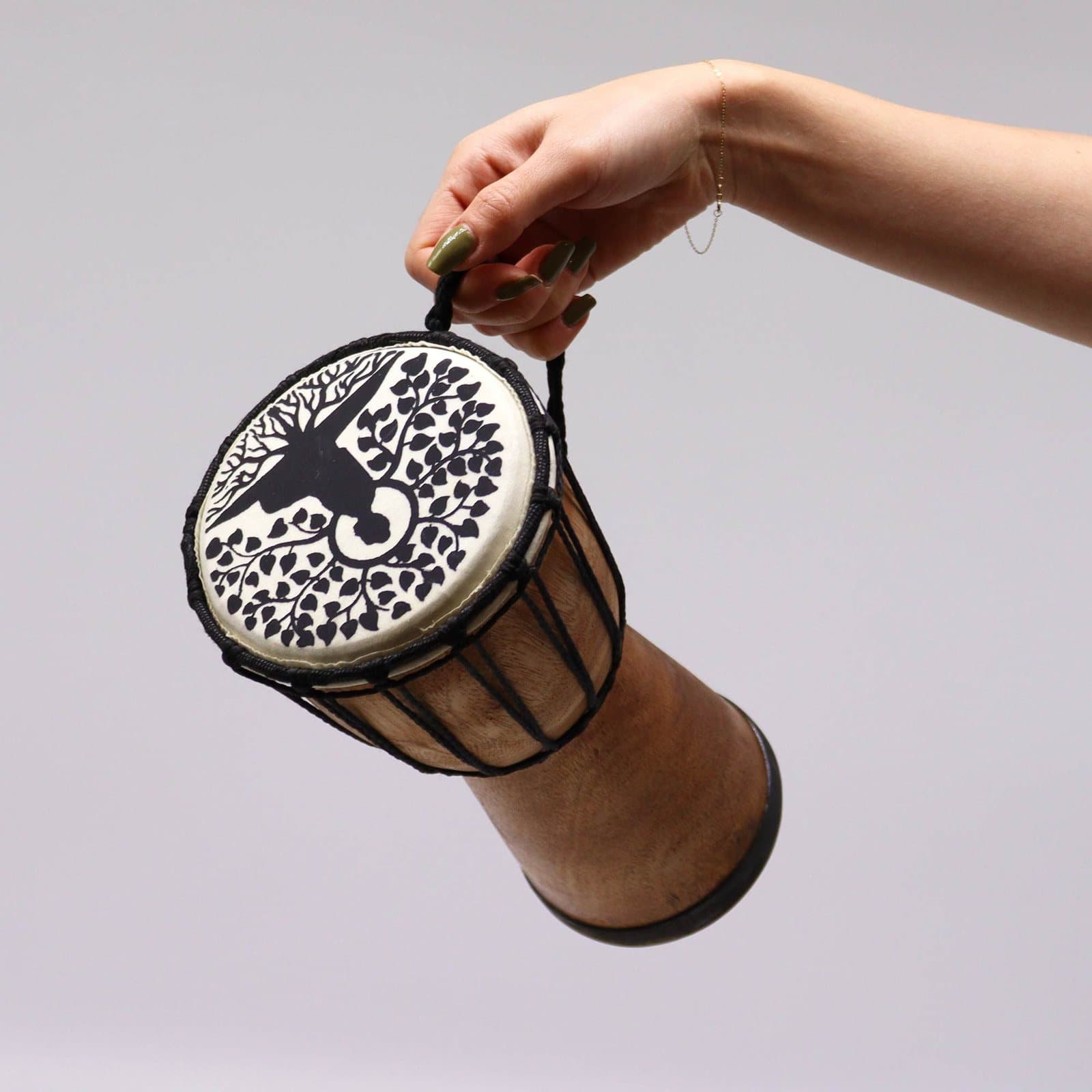 Small wooden djembe drum with Buddha and tree artwork and a wide top