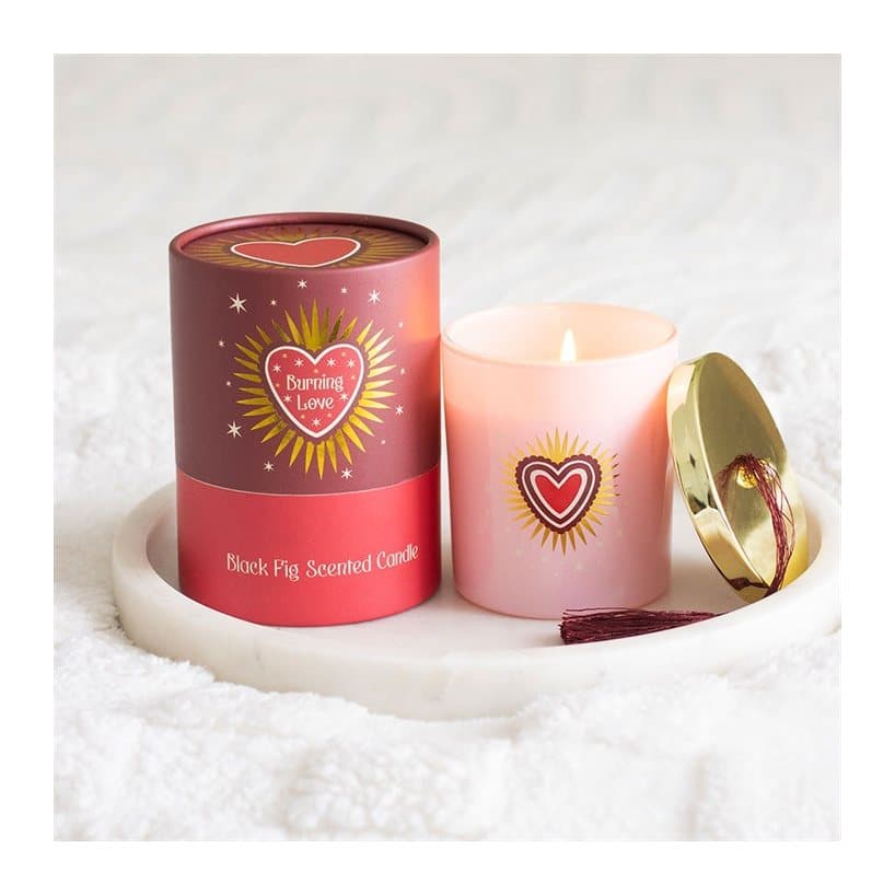 Burning Love black fig candle in a blush pink glass jar with gold lid