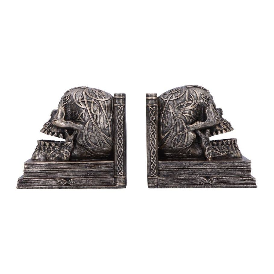 Bronze-coloured skull bookends with Celtic knotwork on stacked book bases