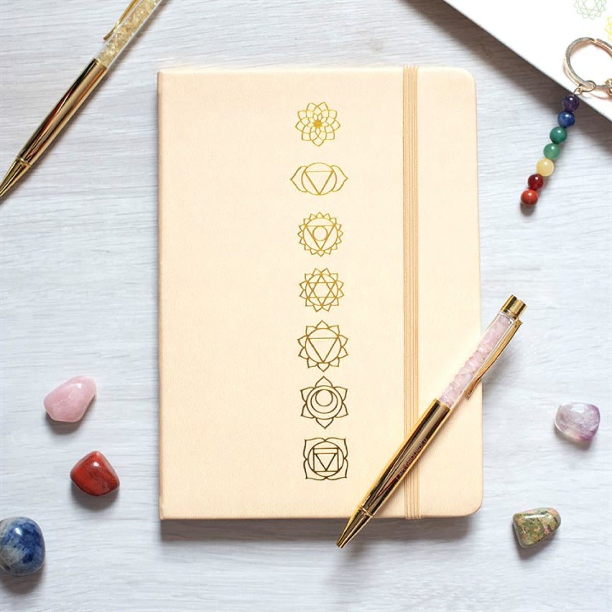 A5 notebook decorated with gold-toned chakra symbols