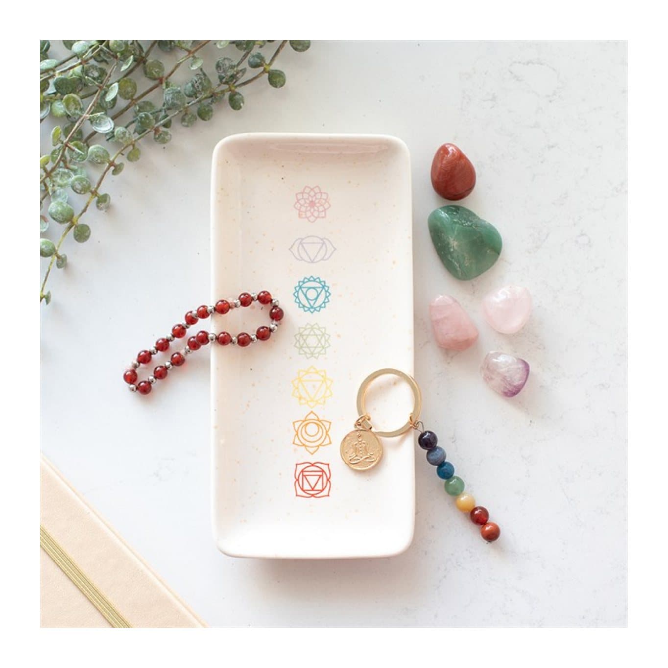 Ceramic trinket dish with a row of colourful chakra symbols