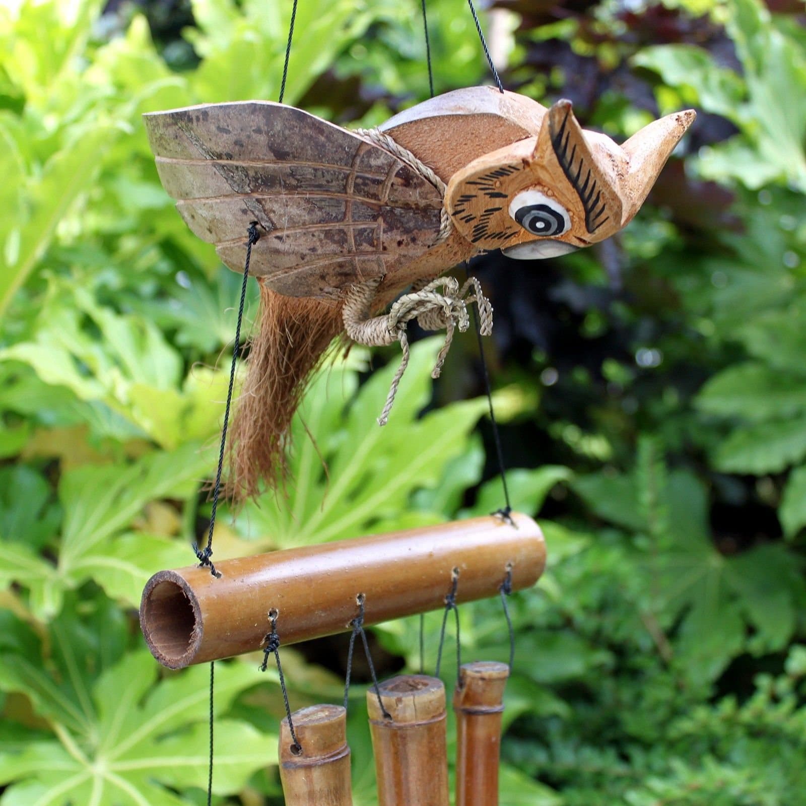 Handmade coconut and bamboo wind chimes with a flying animal figure