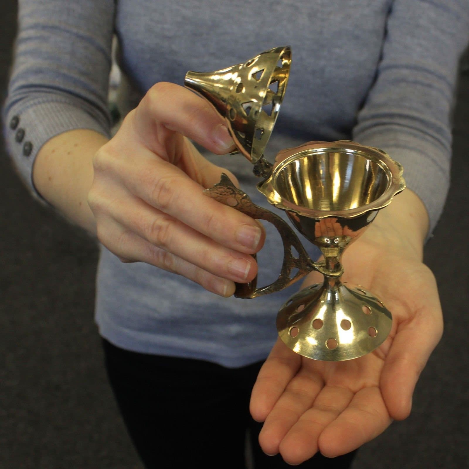 Polished brass cone incense burner with vented lid and wooden grip handle