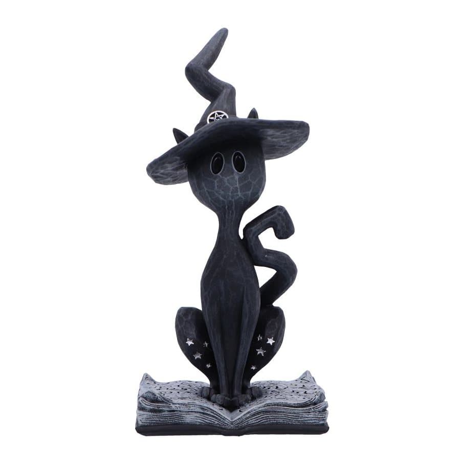 Black cat figurine with a crooked witch's hat on an open spellbook