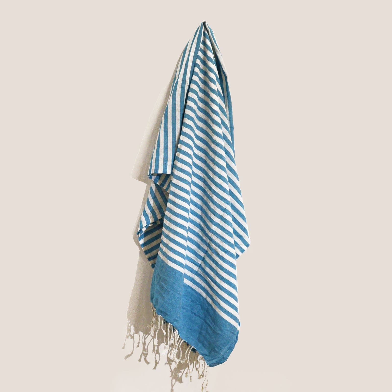 Folded cotton pareo throw wrapped with jute twine and a tag