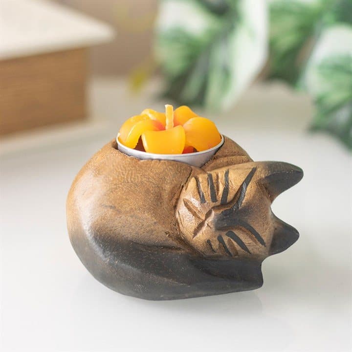 Curled cat tealight holder in monkey pod wood with a flower-shaped tealight cup
