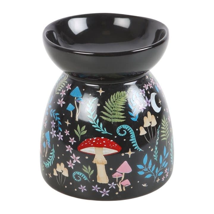 Black steel oil burner with a dark forest design of flora, fauna, moon and stars