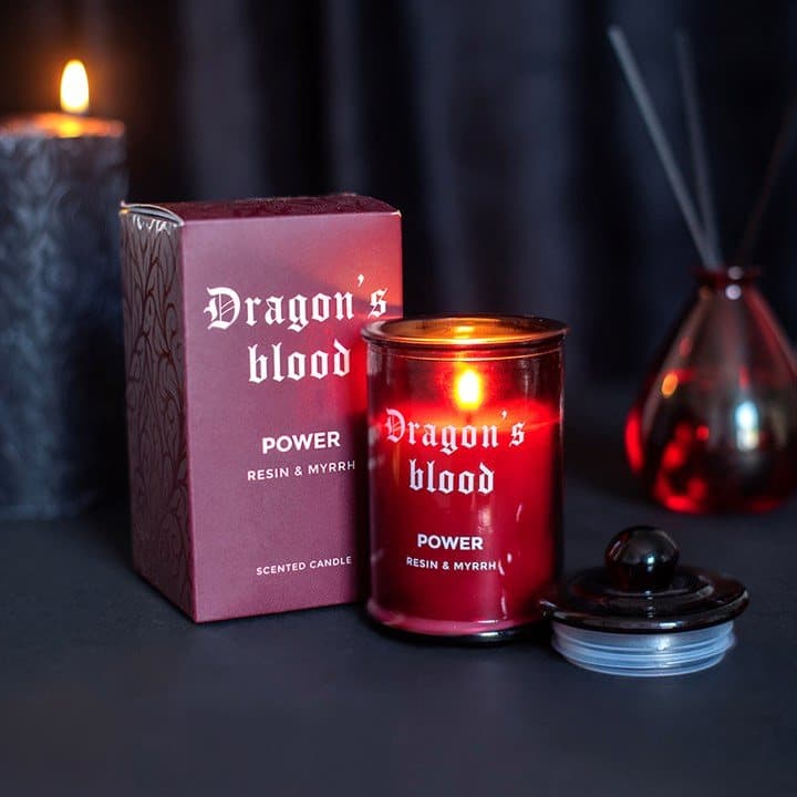 Deep red apothecary-style glass candle labelled Power