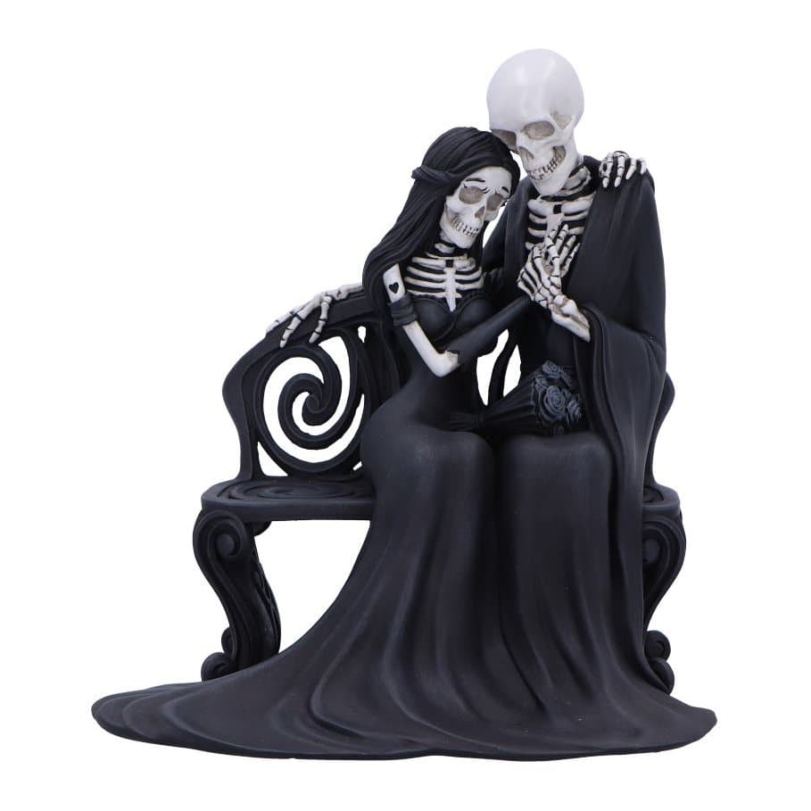 Two skeletons embracing on a bench in a gothic resin figurine
