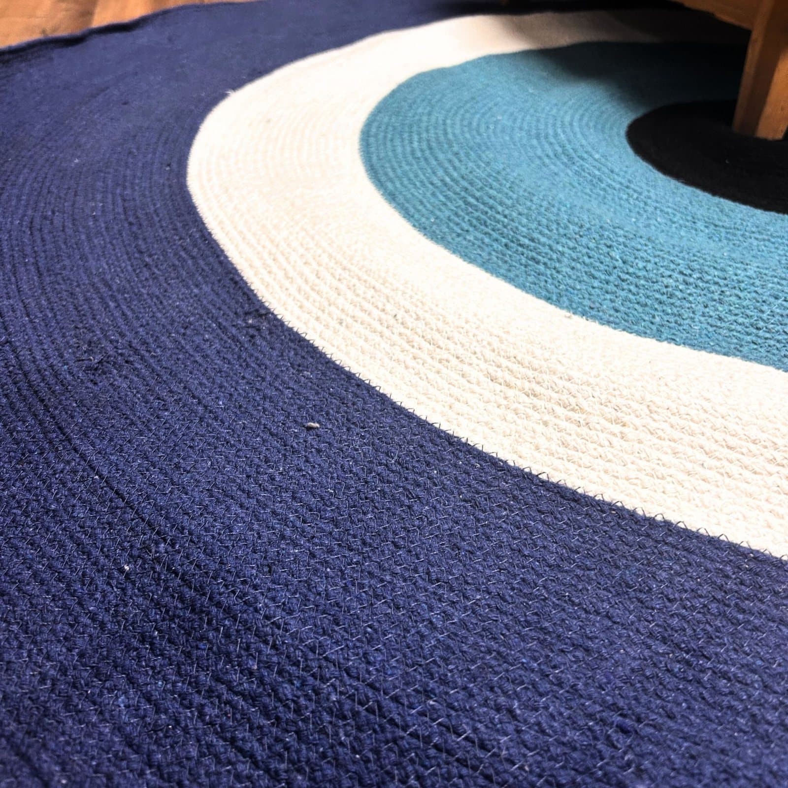 Evil eye cotton rope rug and blue, white and teal striped jute baskets
