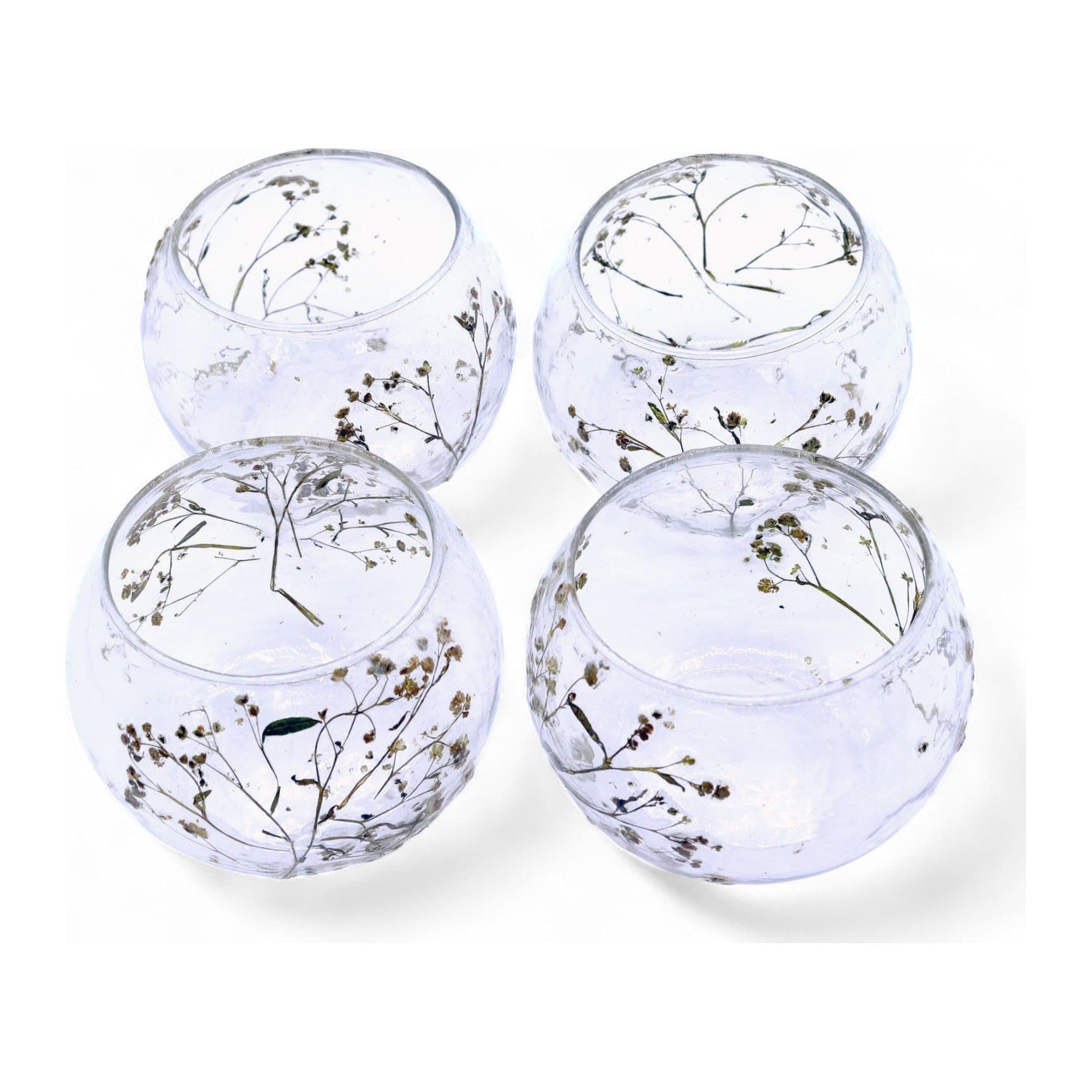 Round glass bowl candle holder with dried flowers embedded in the glass