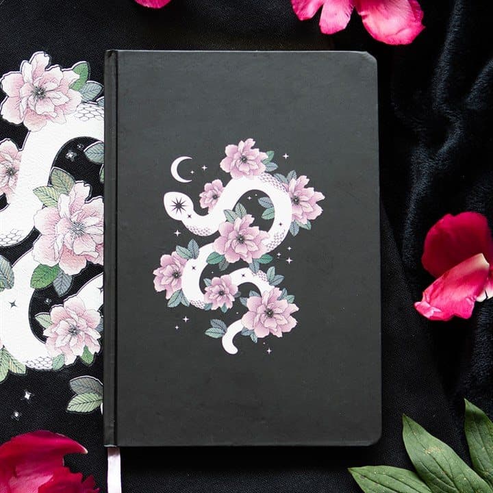 A5 notebook with a curled white snake and soft pink flowers