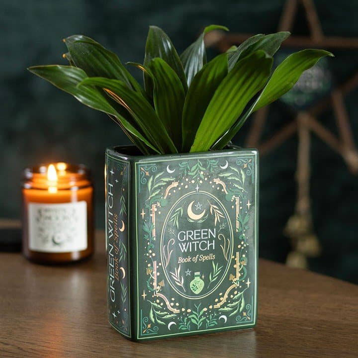 Green ceramic vase shaped like a grimoire with Green Witch artwork