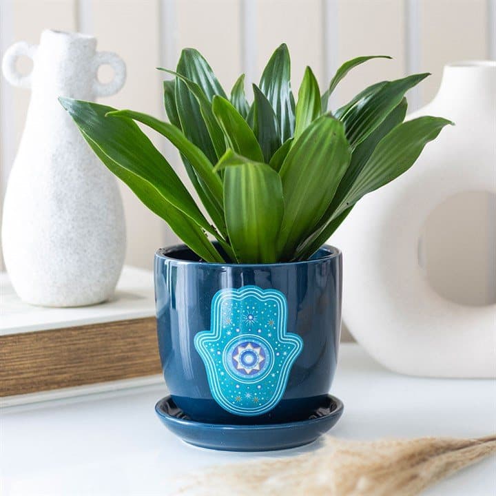 Dark blue ceramic plant pot with a Hand of Hamsa design and a matching saucer