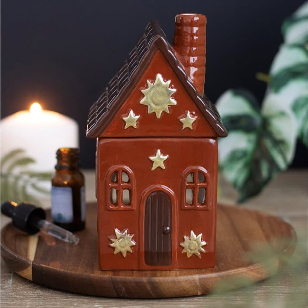 Ceramic cottage-shaped oil burner in terracotta tones with sun details