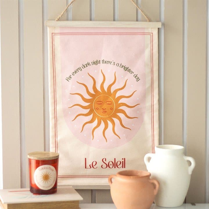 Le Soleil sun wall hanging with a sun design and wording
