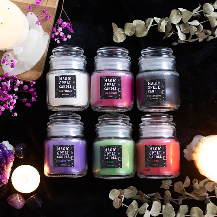 A set of six mini scented spell candle jars in glass