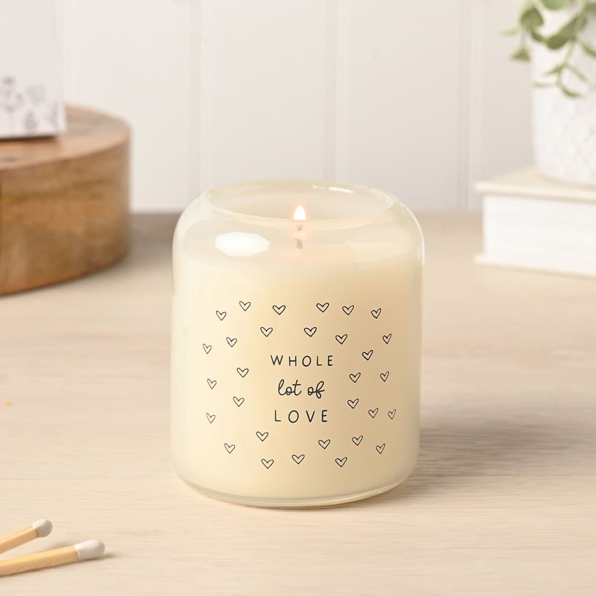 Love glass candle with a heart pattern