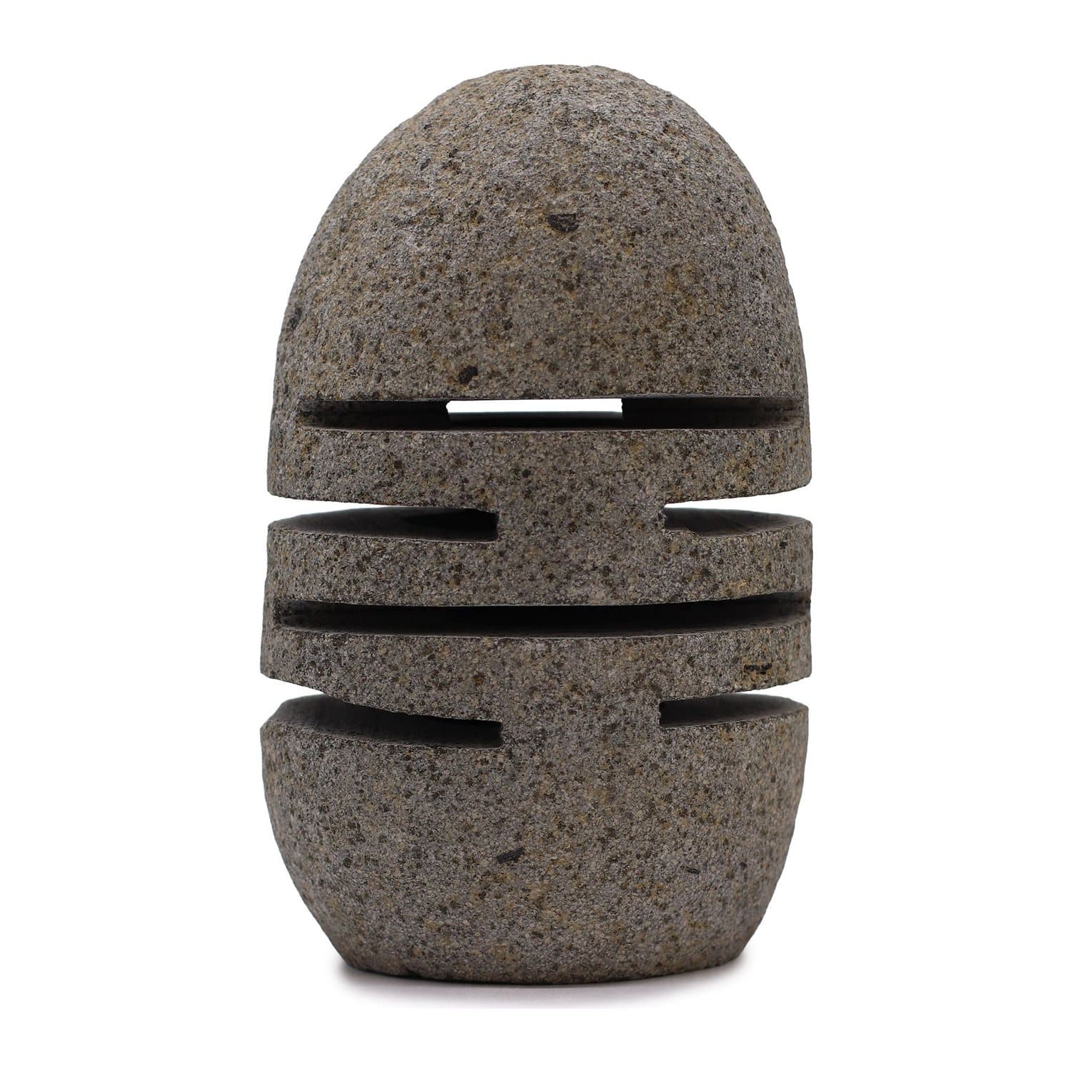 Carved natural riverstone candle holder with candlelight glowing through its cuts