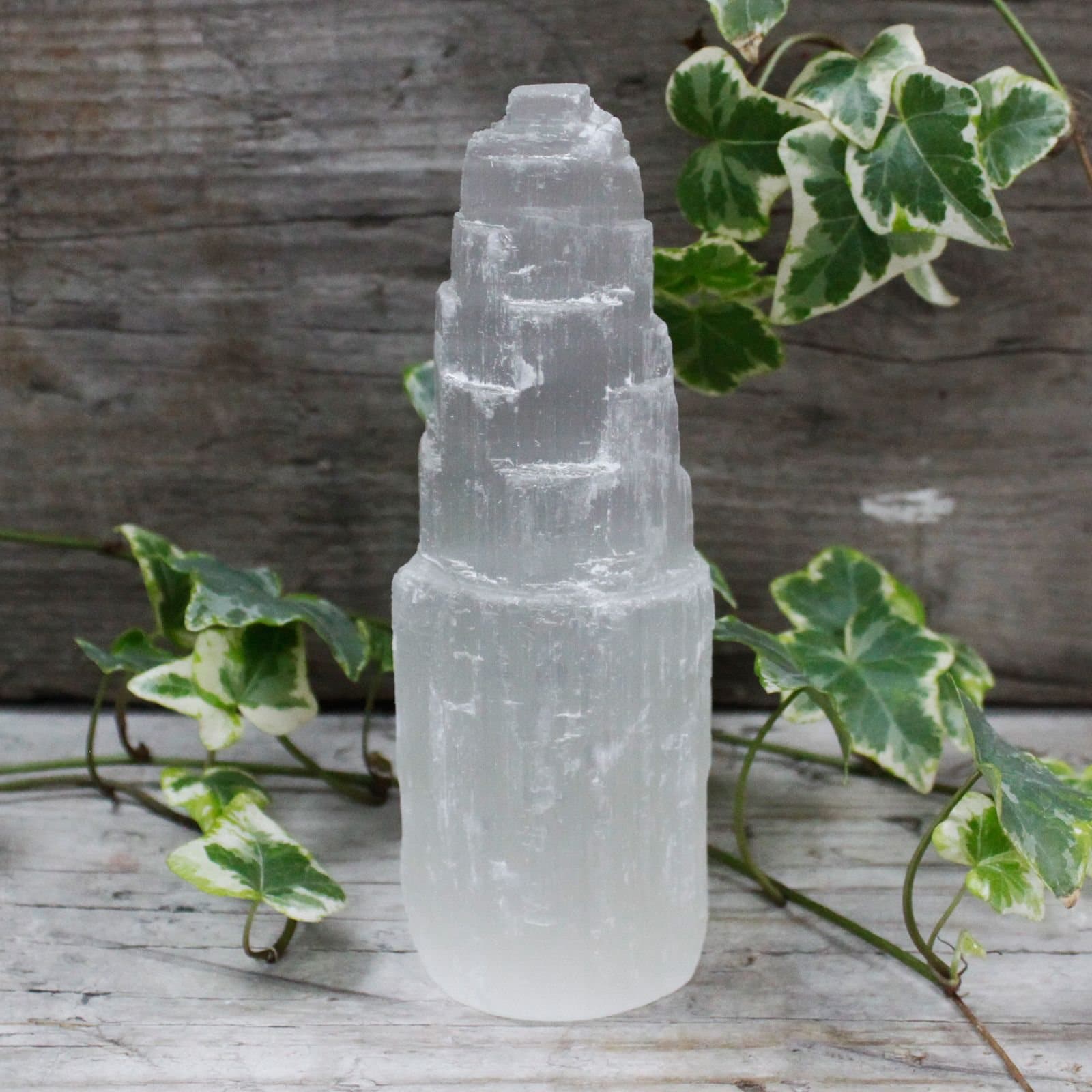 Milky natural selenite crystal tower standing upright