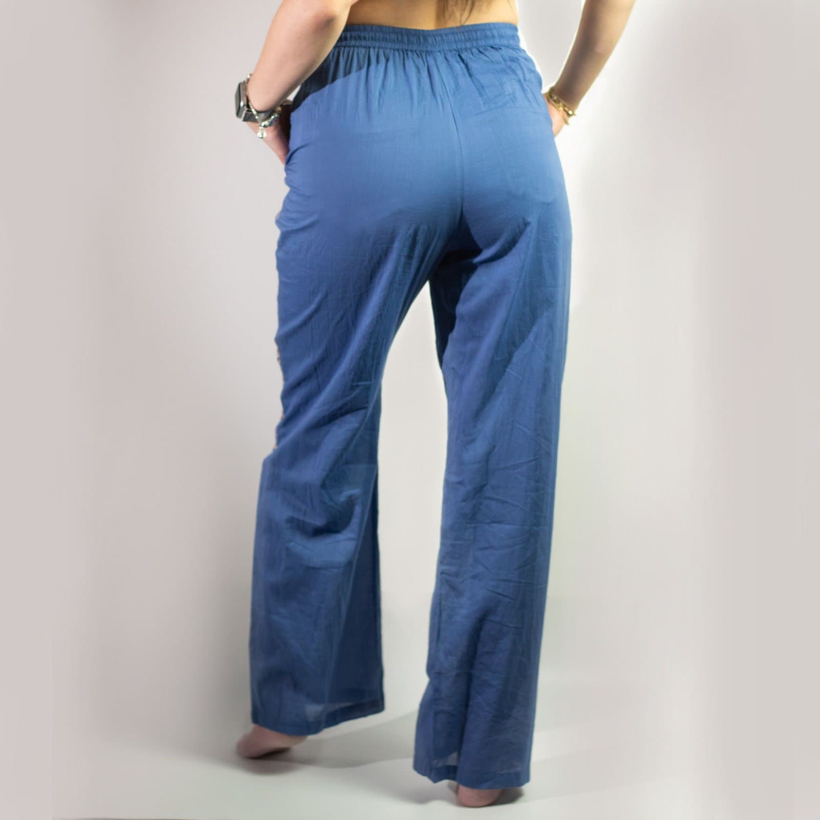 Rich blue lounge pants with hand-painted gold evil eye motifs
