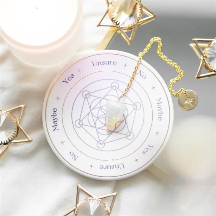 Opalite pendulum above a ceramic Flower of Life base with answer words