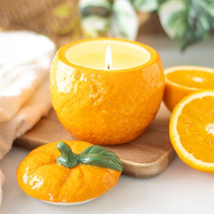 Ceramic scented candle jar shaped like an orange