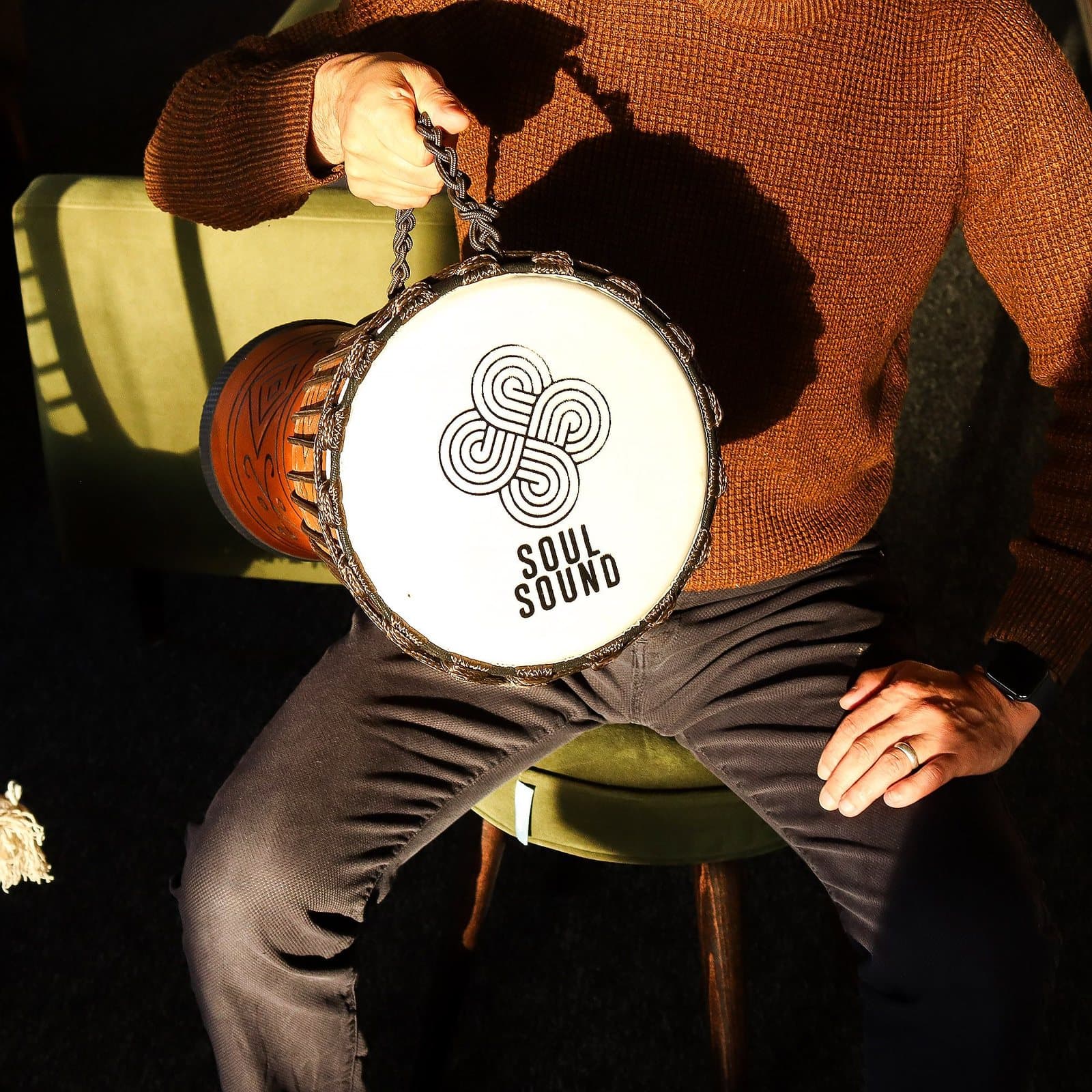 Carved wooden djembe drum with the Soul Sound design on the drum head