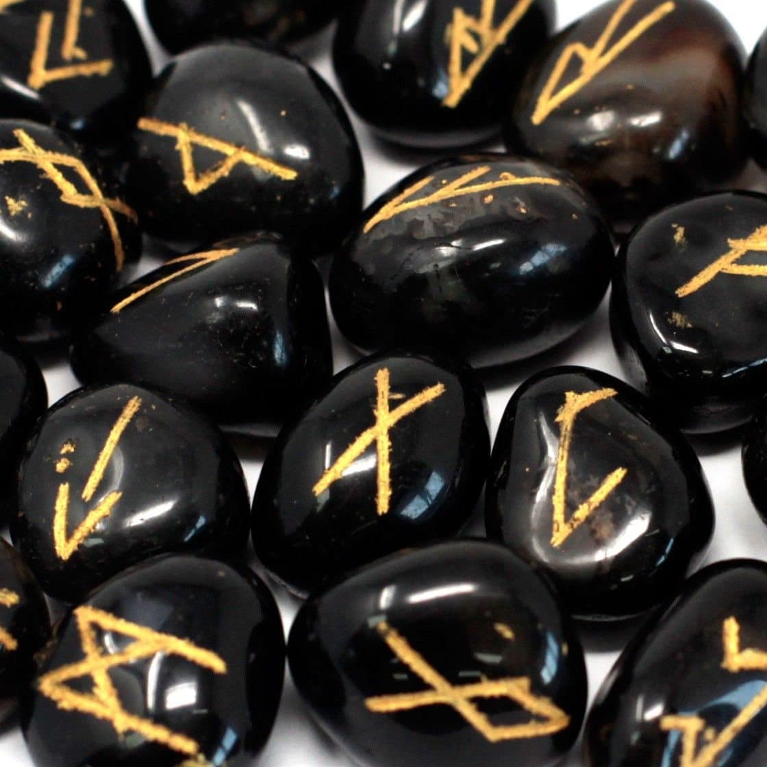 Onyx rune stones carved with rune symbols beside their pouch