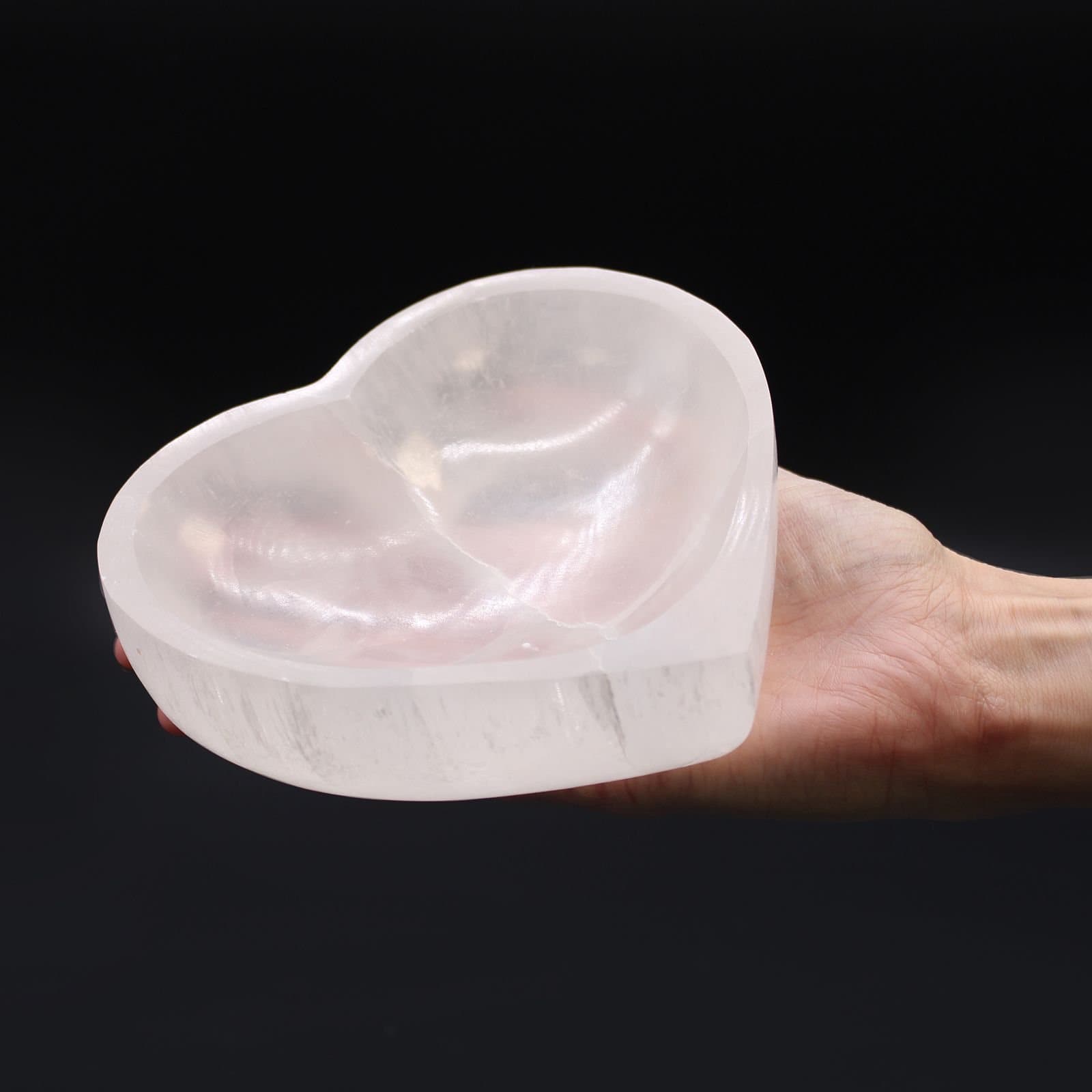Heart-shaped selenite bowl with a natural stone pattern