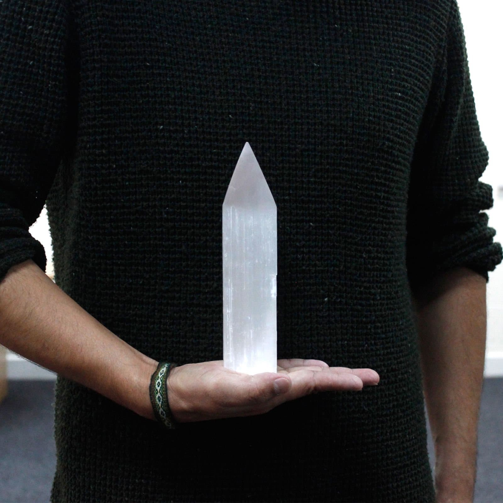 Milky white selenite pencil point tower standing upright