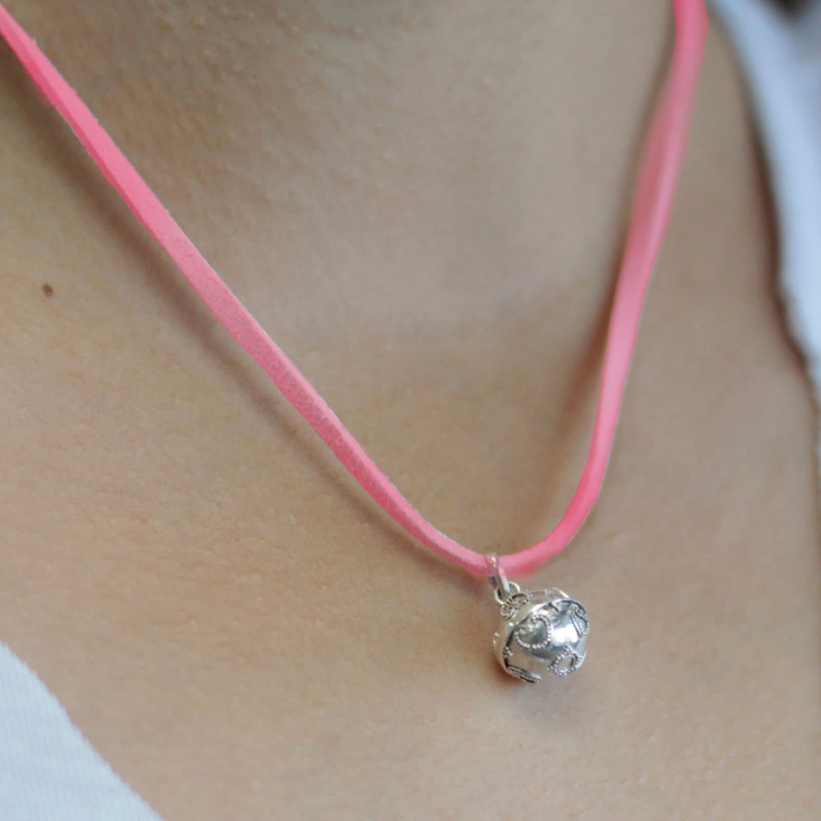 Small 92.5 silver angel bell pendant on a neck cord