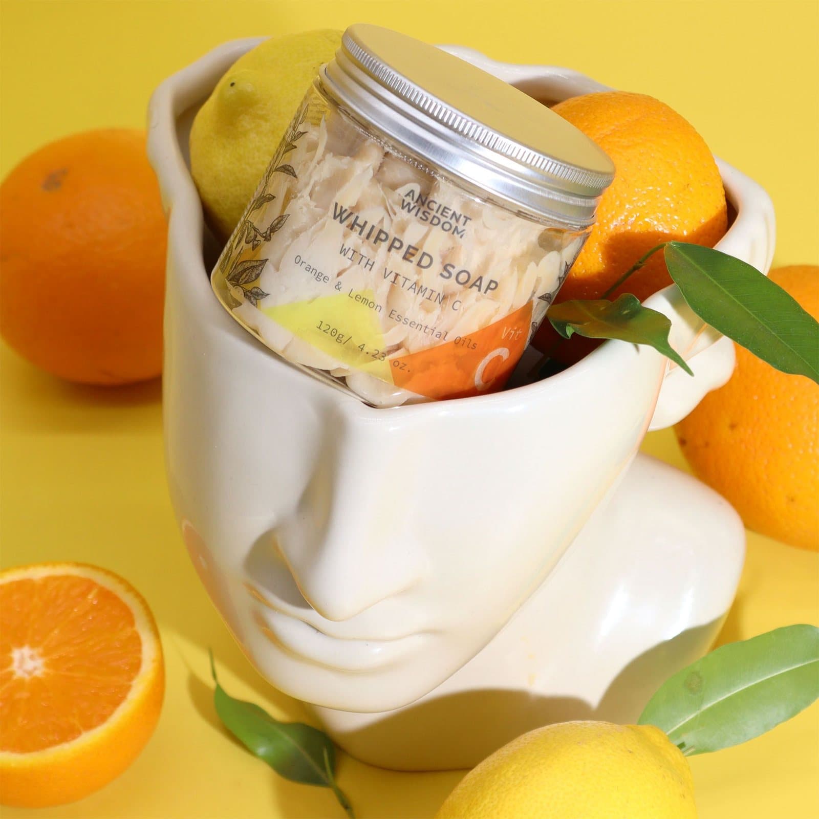 Vitamin C whipped soap in a transparent jar beside a hand soap bar