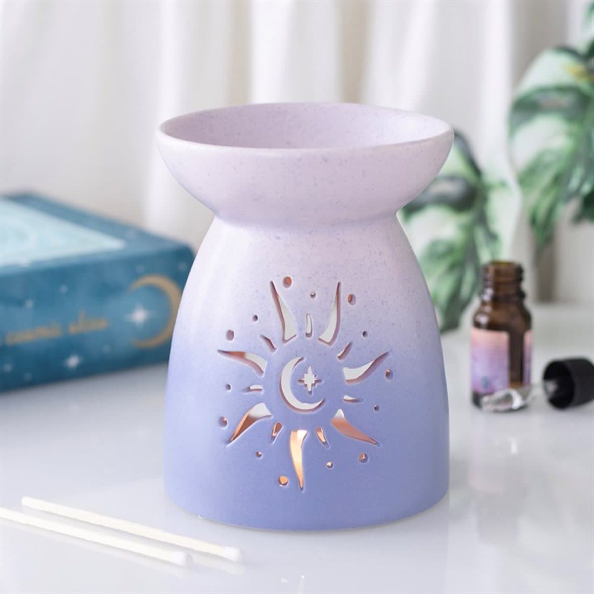 Pastel purple ceramic oil burner with a sun cut-out design
