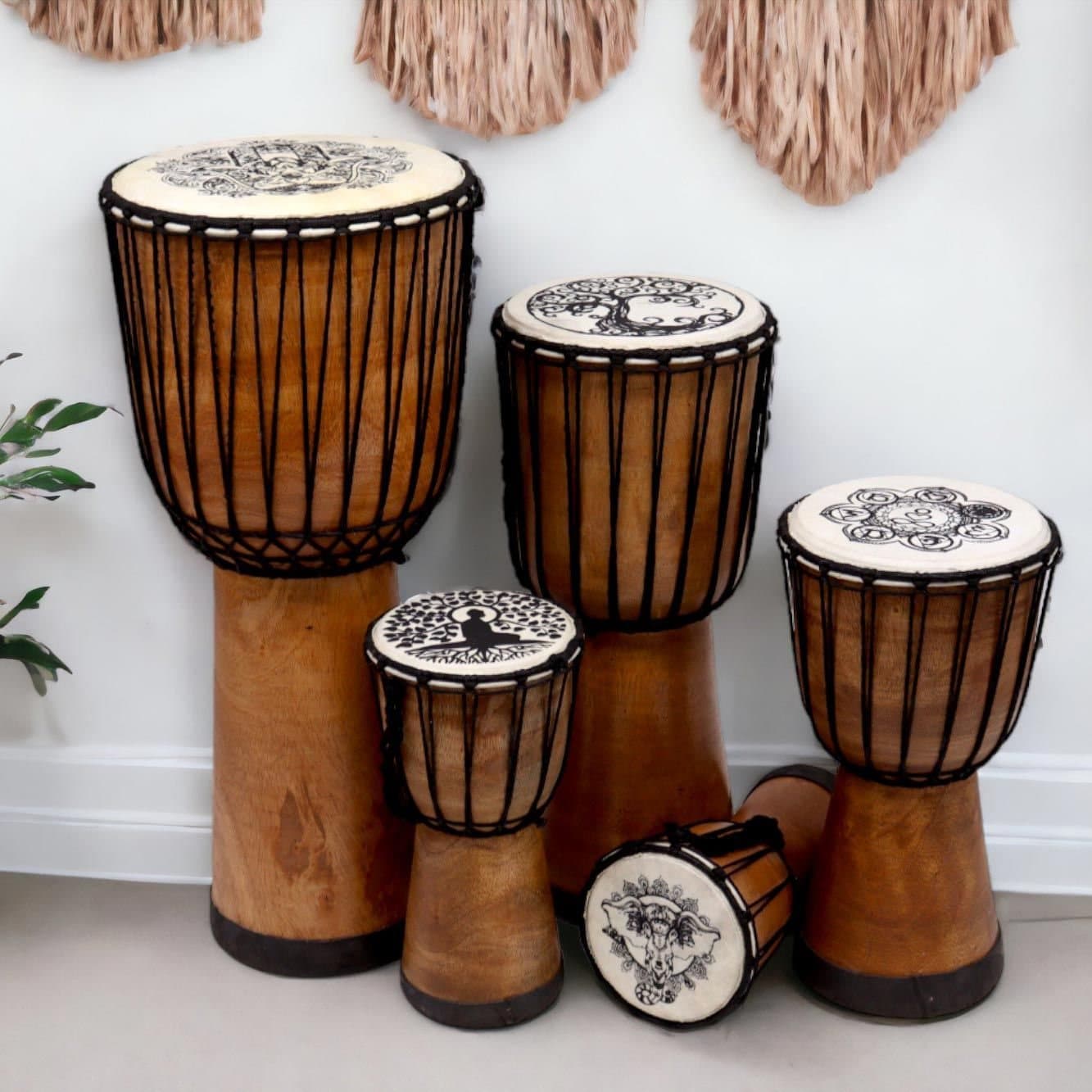 Wooden djembe drum with a goat skin head and Tree of Life artwork