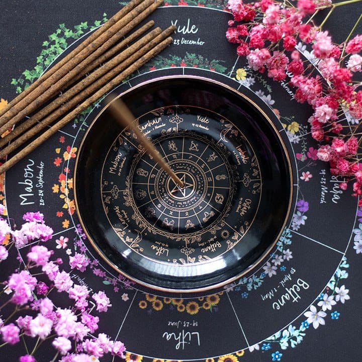 Ceramic incense holder with an illustrated Wheel of the Year design