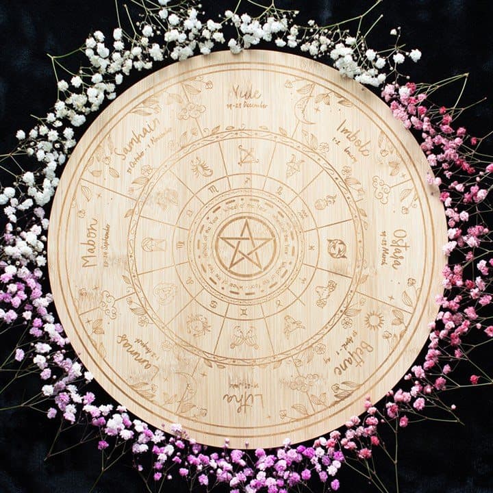 Wooden serving board engraved with the Wheel of the Year symbols