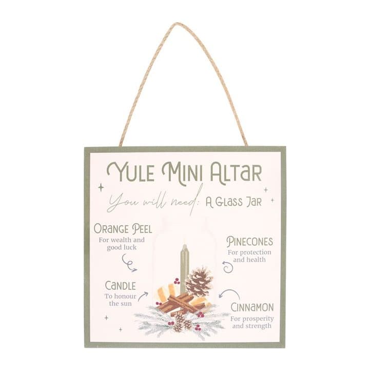 Painted MDF Yule sign showing orange peel, pinecones, cinnamon and a candle