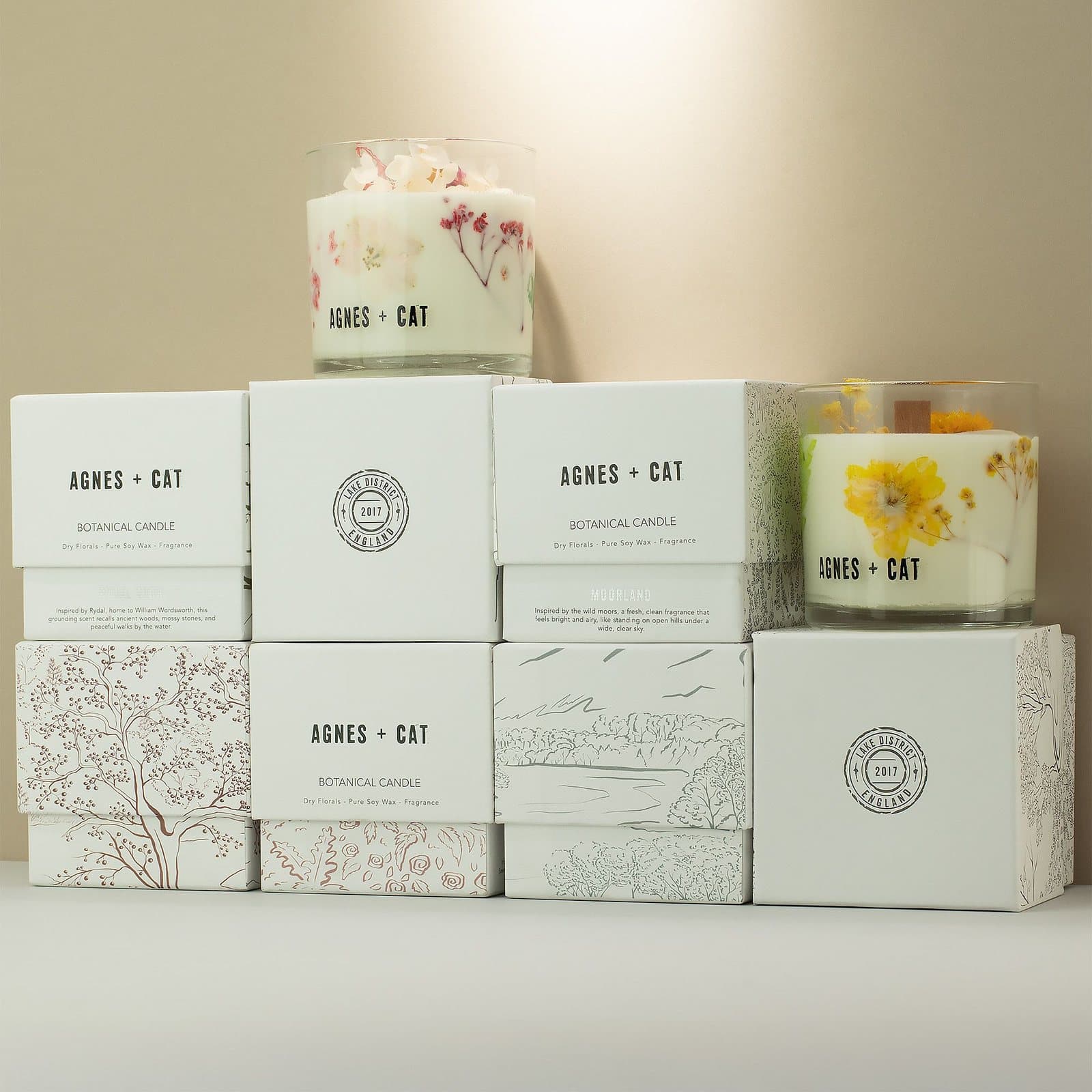 Agnes + Cat botanical soy wax candle with dried florals in a clear glass jar
