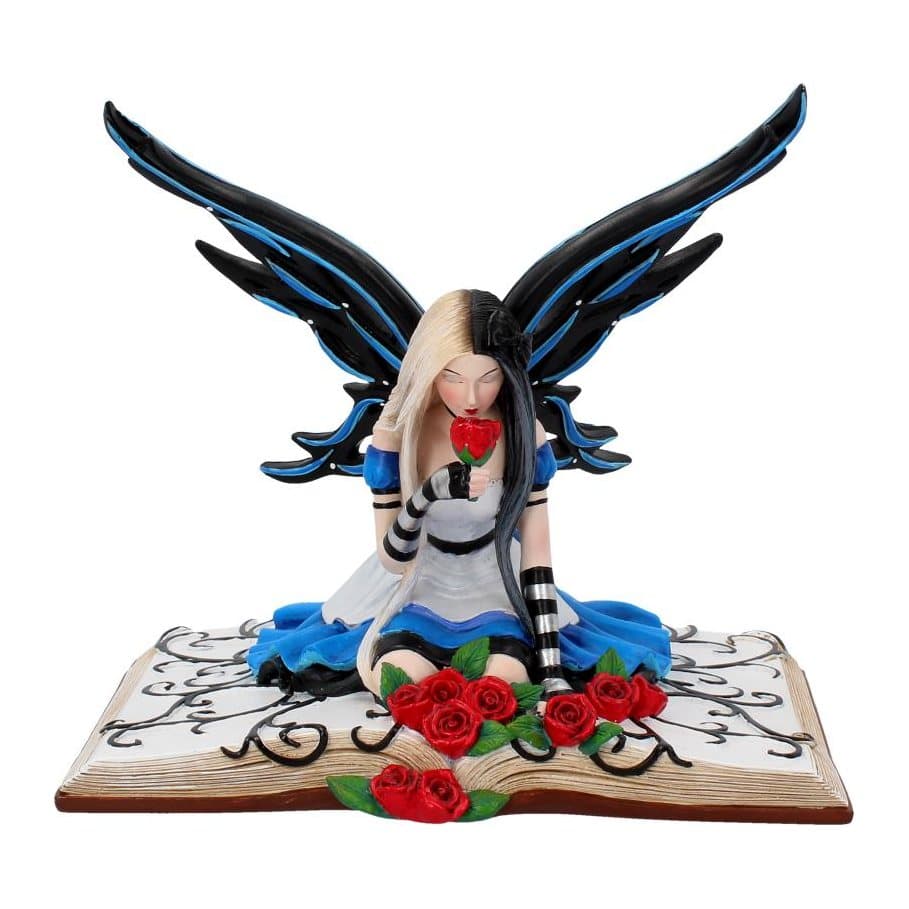 Resin Alice fairy figurine kneeling in a book holding a rose